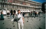 I am doing what millions of tourists did who ever visited Venice- feed pigeons on St.Marco's square. From time to time this square is poured by water, which appears quite suddenly. But with they same speed there rise wooden desks which stand on the necessary height. So you may not worry about your shoes in Venice :)